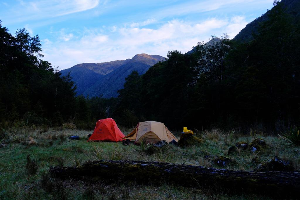 Camp with unnamed peaks in the background.