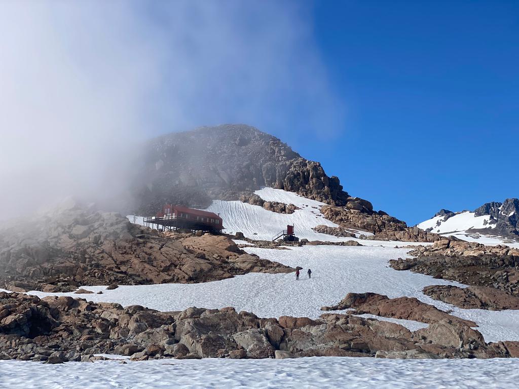 Looking back at Mueller Hut managing to stay out of the cloud.