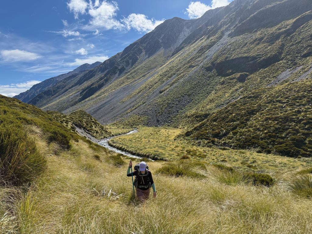 Jen climbing up from Hunts Creek with the eroded moraine in the background.