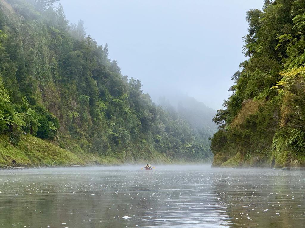 Hayleigh and Tim paddling through the morning mist.