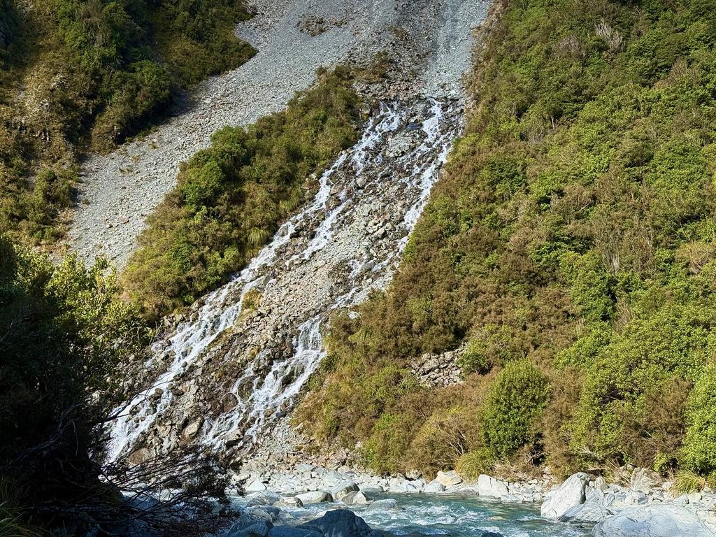 A cool creek that travelled under the screen until appearing to come out of the side of the hill.
