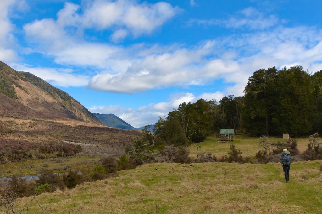 Coming up on Hope Halfway Hut situated in a large clearing.