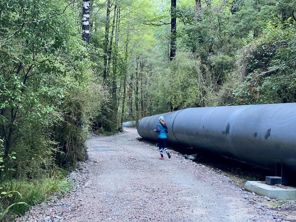 Jen next to the hydroelectric pipe.