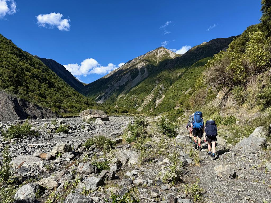 Not far now! The hut is on the grass ahead across the river.