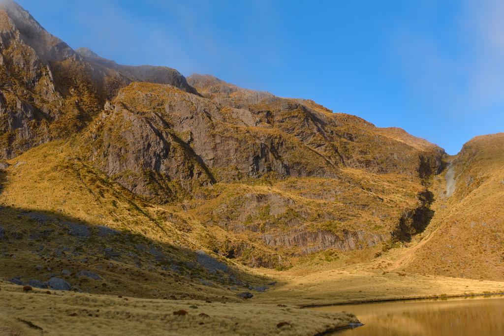 Climb the rocky gully and the traverse tussocked faces to Point 1489 center left.