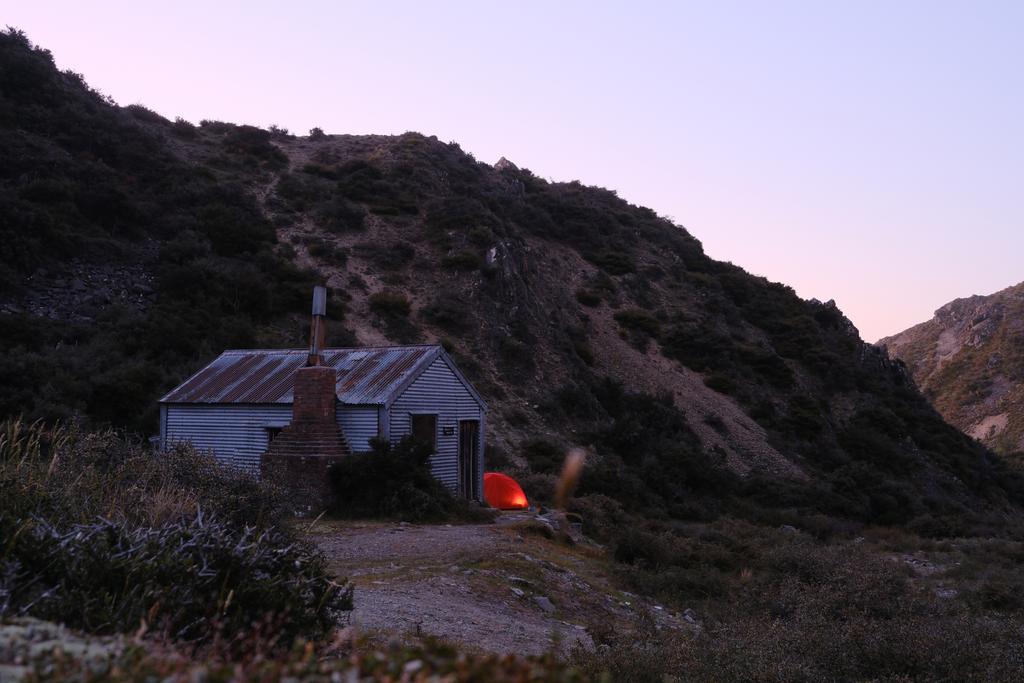 Mānuka Hut under a beautiful, gentle sunset.